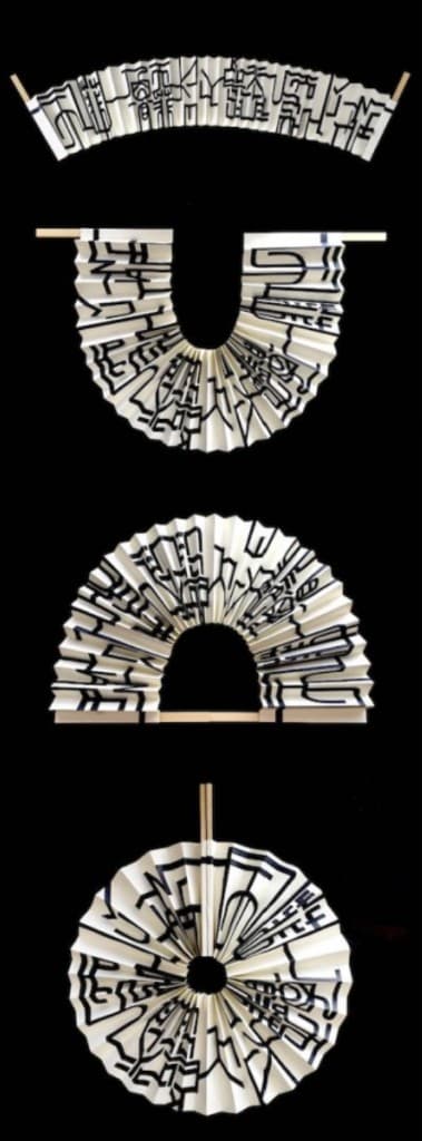 Folded paper forms covered in black linework