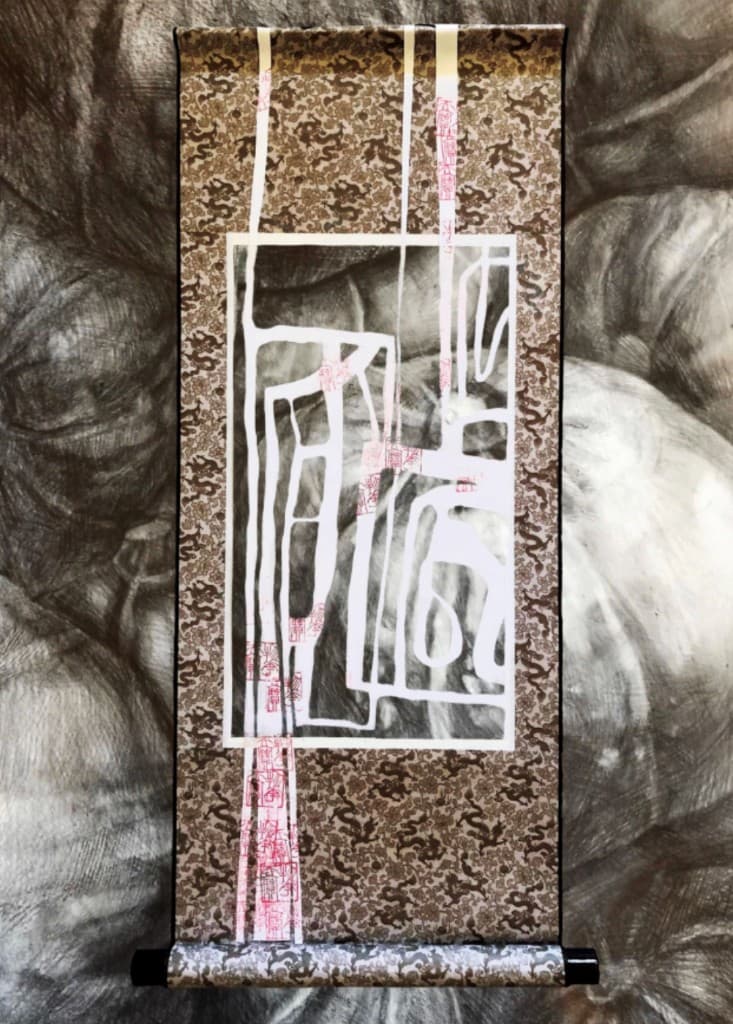 A layered hanging scroll in black, white, brown, and pink